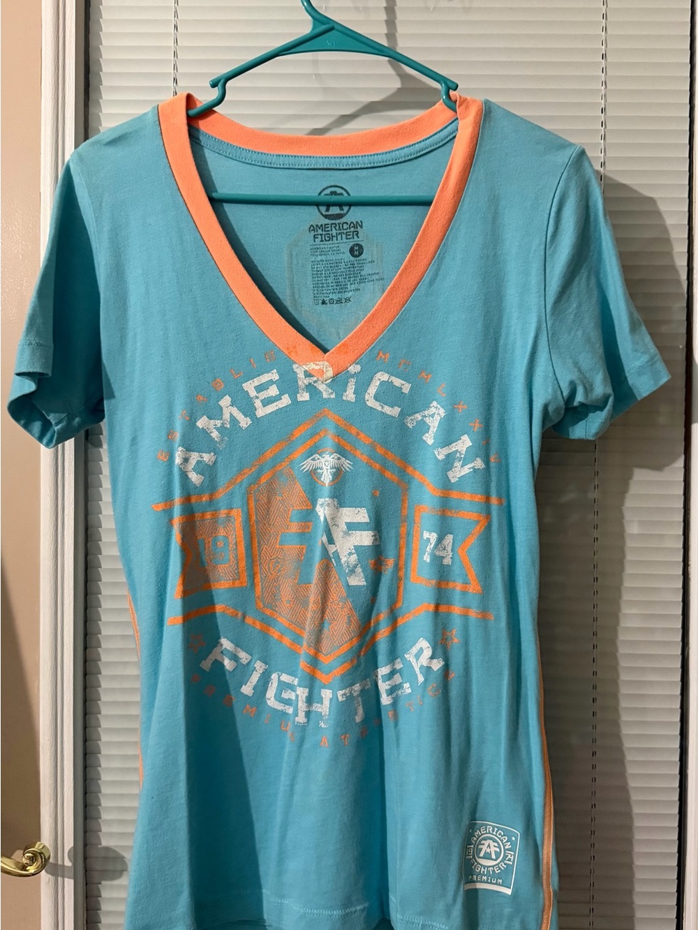 American Fighter Teal Short Sleeve V-Neck Tee with Coral Graphic